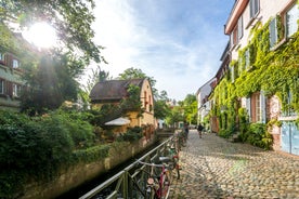 Photo of aerial view of the historic city center of Freiburg im Breisgau from famous old Freiburger Minster in beautiful evening light at sunset, Germany.