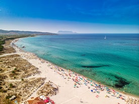 Photo of aerial view of Pittulongu, White Beach in Olbia, blue water, amazing Vegetation and sandy beaches with Tavolara island view, Italy.