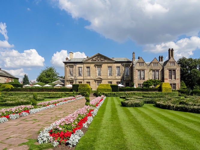 photo of Coombe Abbey Hotel with garden and flower beds in Coventry, England.