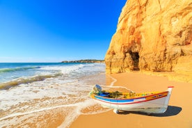 photo of an aerial view of wide sandy beach in touristic resorts of Quarteira and Vilamoura, Algarve, Portugal.