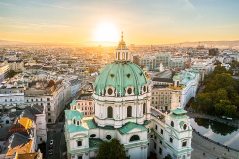 Photo of aerial drone view of St. Charles Church "Karlskirche" at sunset, Vienna, Austria.