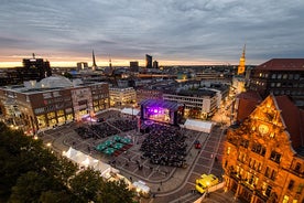 Cologne Aerial view with trains move on a bridge over the Rhine River on which cargo barges and passenger ships ply. Majestic Cologne Cathedral in the background.