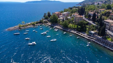 Photo of Ika village waterfront in Opatija riviera, turquoise sea and blue sky, Kvarner, Croatia.