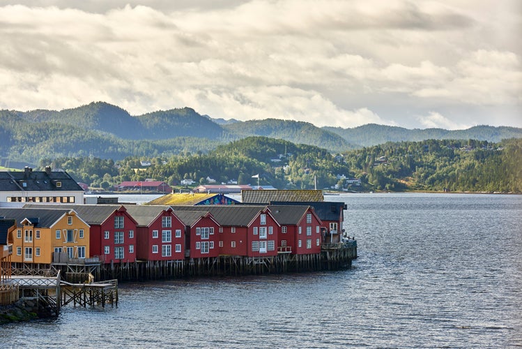 photo of view of Namsos, a typical village of fishermen and woodcutters overlooking the sea, in the Namsfjord. Town with the famous red wooden houses, on a cloudy day at dawn.