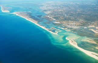 Photo of aerial view of pier fishing boats in the village Cabanas de Tavira, Portugal.