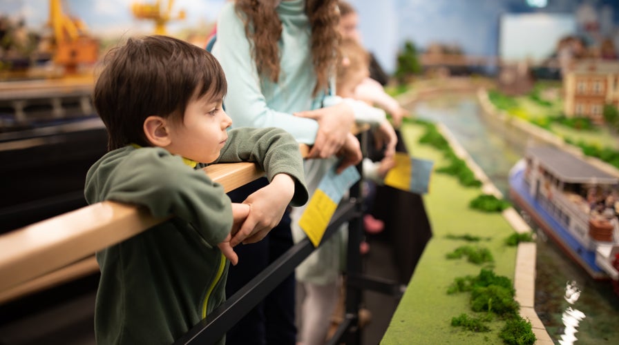 Portrait of little boy attentively watching displays in park of Wroclaw miniatures, Kolejkowo.jpg