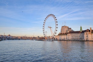 London, England - Panoramic skyline view of Bank and Canary Wharf, central London's leading financial districts with famous skyscrapers at golden hour sunset with blue sky and clouds.