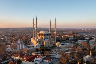 Touristic sightseeing ships in Golden Horn bay of Istanbul and mosque with Sultanahmet district against blue sky and clouds. Istanbul, Turkey during sunny summer day.