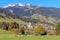 photo of houses and cows in green meadows at Jochberg in Tyrol at Kitzbuehler Alps, Austria.