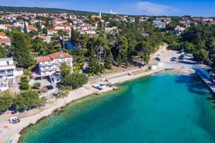 photo of aerial panoramic view of beautiful town of Lovran and sea walkway in Croatia.