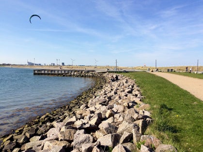 Photo of Amager Strandpark, with foreground rocks lit up by the morning light, Copenhagen, Denmark.