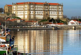 Porto, Portugal old town ribeira aerial promenade view with colorful houses, Douro river and boats.