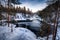 Photo of Myllykoski watermill at Pieni Karhunkierros hiking trail during cold and wintery day with rapids flowing in Finland.