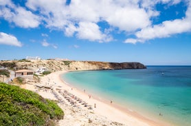 Photo of aerial view of beautiful lighthouse located on high cliffs of Saint Vincent cape in Sagres, Algarve, Portugal.