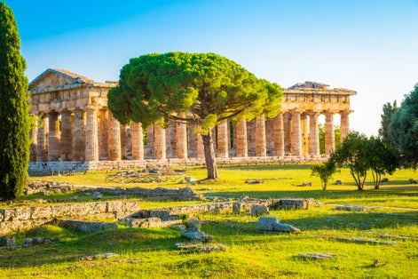 photo  of view of Beautiful view of famous Paestum Temples Archaeological UNESCO World Heritage Sitein in scenic golden evening light at sunset, Province of Salerno, Campania, Italy