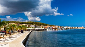 Photo of white boat in crystal clear blue sea water, Argostoli, Greece.