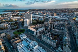 Photo of aerial view of Aberdeen as River Dee flows in a curve to the North Sea showing Duthie Park with bridge and traffic from south.