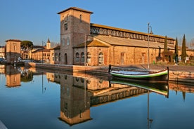 Photo of Cervia's canal, where the Salt Museum is located, with reflections on the water ,Italy.