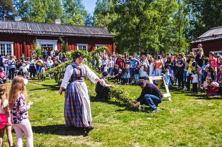 Umea, Sweden, Happy people enjoy watching pole standing moment while a beautiful woman passing by.