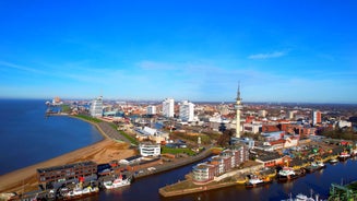 Photo of aerial view of the city of Bremerhaven with the harbor and traditional sailing-ships, Germany.