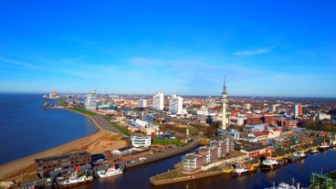 Photo of aerial view of the city of Bremerhaven with the harbor and traditional sailing-ships, Germany.