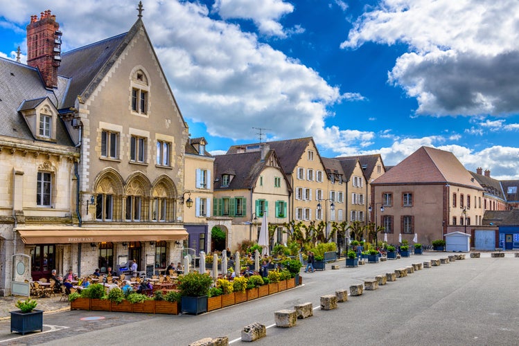 Old street with old houses and tables of cafe in a small town Chartres, France. Architecture and landmarks of Chartres. Cityscape of Chartres