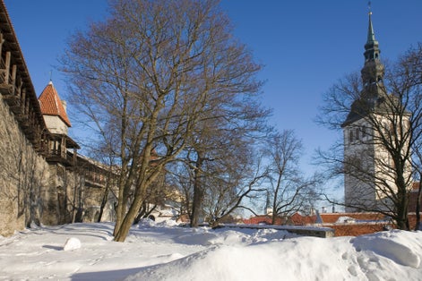 Photo of Walls and towers of old Tallinn around Danish king's garden in winter, Estonia.