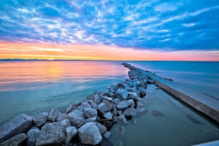 Photo of Pier and sea in town of Grado sunrise view, Italy.