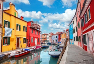 Famous buildings, gondolas and monuments by the Rialto Bridge of Venice on the Grand Canal, Italy.