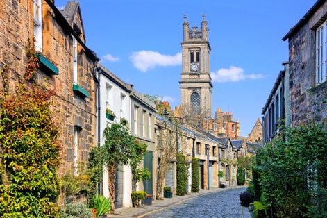 photo of view of Quaint old residential street with church spire in Edinburgh Scotland during springtime