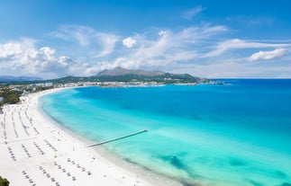 Photo of aerial view of the harbour of Port de Pollença, a seaside village located on the northern coast of Mallorca in the Balearic Islands, Spain.