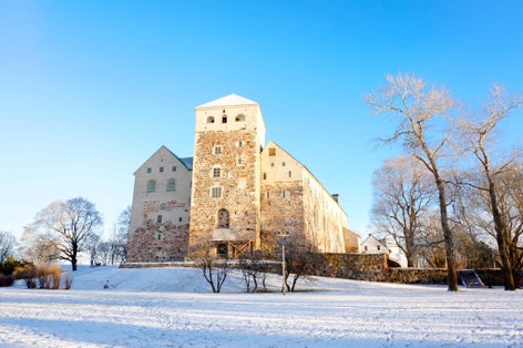 Photo of winter landscape of Turku castle medieval building in the city of Turku in Finland.