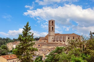 Photo of Italy Piazza Maggiore in Bologna old town tower of town hall with big clock and blue sky on background, antique buildings terracotta galleries.