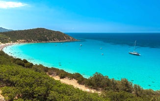 Photo of aerial view of a beautiful bay with azure sea from top of a hill, Villasimius, Sardinia island, Italy.