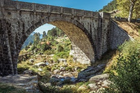 photo of Poço da Broca waterfall in Serra da Estrela Natural Park, Barriosa, municipality of Seia in Portugal, with a viewpoint in the foreground, at the end of a spring day.