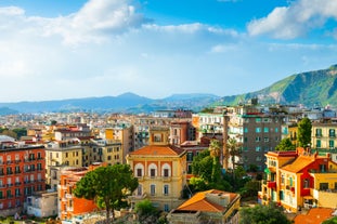 Naples, Italy. View of the Gulf of Naples from the Posillipo hill with Mount Vesuvius far in the background and some pine trees in foreground.