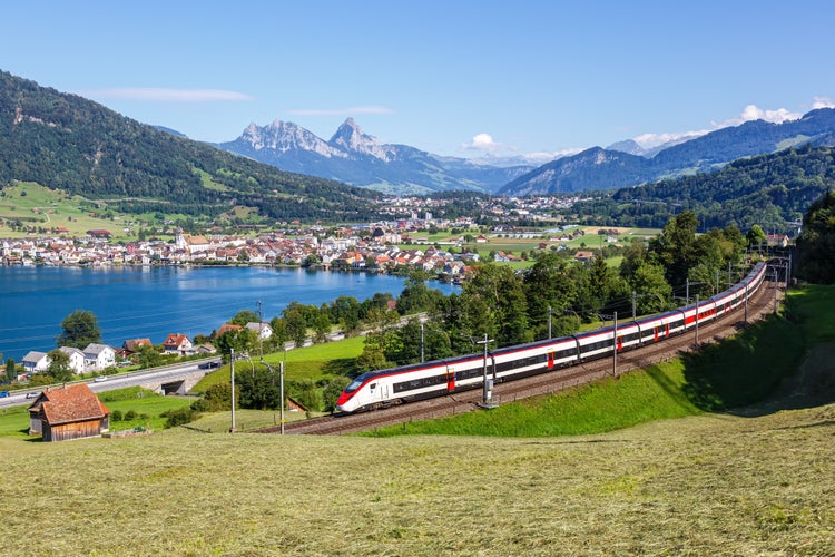 photo of passenger train type Stadler Giruno Smile of Schweizerische Bundesbahnen SBB at Grosser Mythen mountain at Lake Zug in the Swiss Alps in Arth, Switzerland.