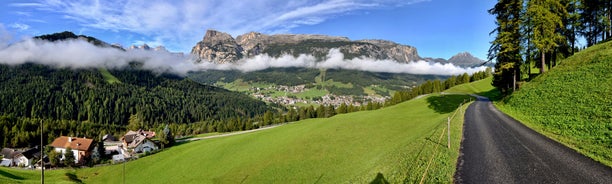 photo of Autumn morning panoramic shot on Stern-La Villa from San Cassiano, Piz la Ila, Gruppo Sella, Sassongher, Piza de Gherdenacia, Peitlerkofel in Italy.