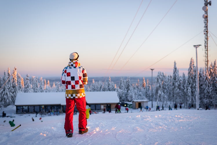 photo of skier/snowboarder in Oslo winter park during winter holidays at sunset in Norway.