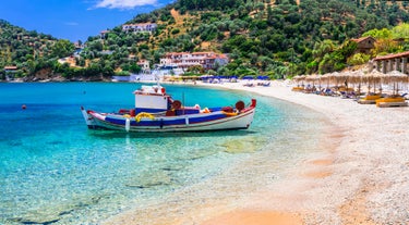 Photo of aerial view of Pythagorio port with colourful houses and blue sea, Samos island, Greece.