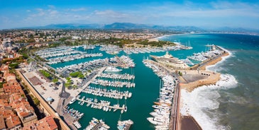 Photo of aerial cityscape view on French riviera with yachts in Cannes city, France.