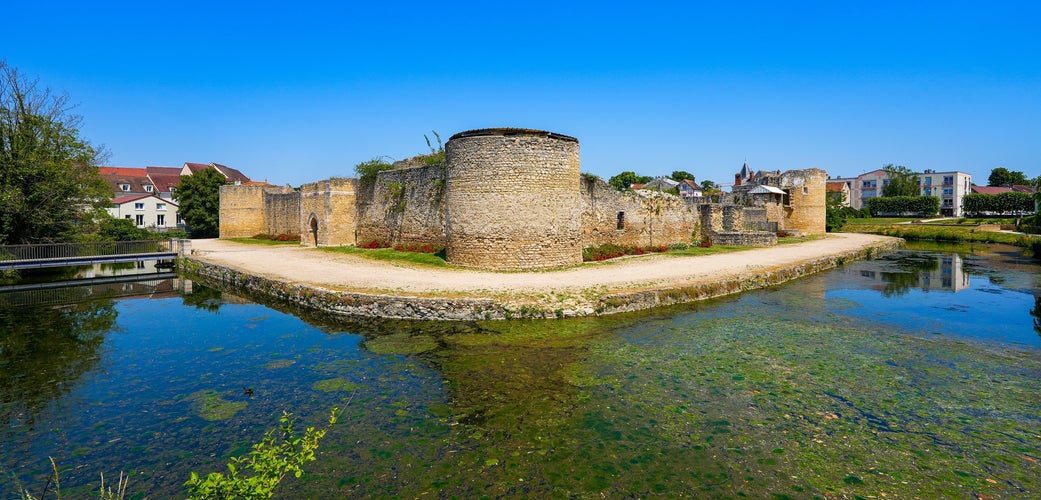 photo of view of Water-filled moat below the round corner tower of the medieval castle of Brie Comte Robert , France.