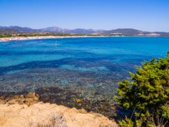 Photo of aerial view of Pittulongu, White Beach in Olbia, blue water, amazing Vegetation and sandy beaches with Tavolara island view, Italy.