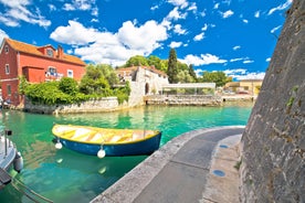 Photo of panorama and landscape of Makarska resort and its harbour with boats and blue sea water, Croatia.