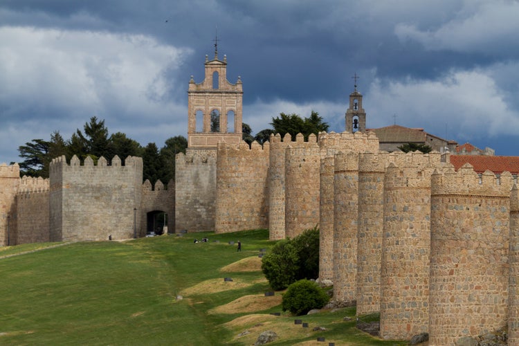 photo of view of Avila Medieval Walls with Puerta del Carmen Gate and Bell Gable - Avila, Spain.