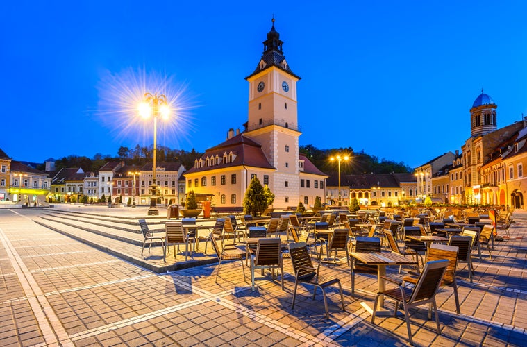 Brasov, Transylvania, Romania. Twilight scenery with Main Square and Council House in medieval center of Brasov, Black Church illuminated