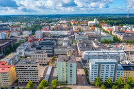 Aerial view of the Tampere city at sunset. Tampella building. View over Tammerkoski river in warm sunlight.