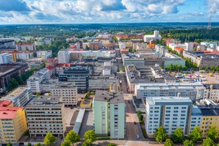 Aerial view of the Tampere city at sunset. Tampella building. View over Tammerkoski river in warm sunlight.