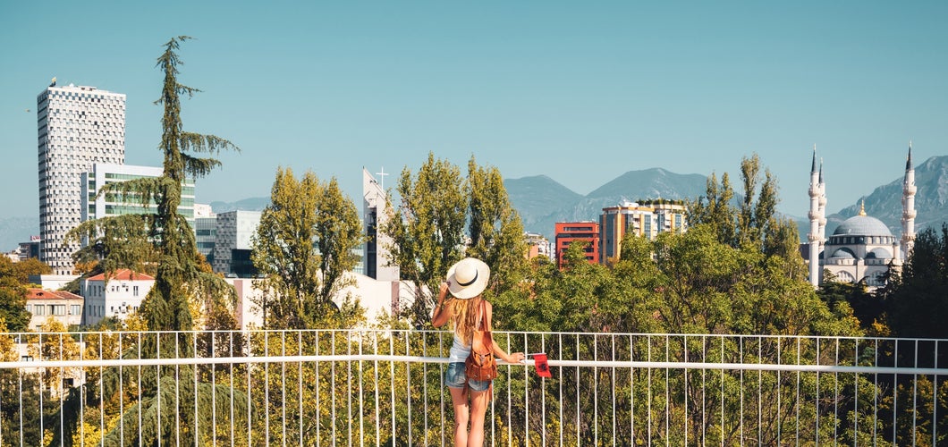 Traveler woman enjoying panoramic view of Tirana city- travel, tour tourism, vacation in Albania