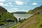 Photo of the waters flowing over the top of the main dam at Caban Coch dam in the Elan valley of Wales.